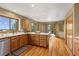 Open-concept kitchen has a central island, wood floors and view to exterior deck at 6882 Snowshoe Trl, Evergreen, CO 80439