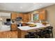 Efficient kitchen has wood cabinets, white counters, and breakfast bar at 6882 Snowshoe Trl, Evergreen, CO 80439