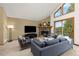 Comfortable living room featuring a stone fireplace, large windows, and cozy seating at 6882 Snowshoe Trl, Evergreen, CO 80439