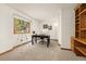 Home office with a telescope, desk, and built-in shelves with a large window providing natural light at 6882 Snowshoe Trl, Evergreen, CO 80439