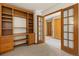 Office space with beautiful built-in shelving and french doors at 6882 Snowshoe Trl, Evergreen, CO 80439