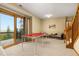 Spacious recreation room with ping pong table, walk-out patio, and comfortable seating at 6882 Snowshoe Trl, Evergreen, CO 80439