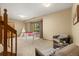 Lower level recreation room with walk-out patio and comfortable seating at 6882 Snowshoe Trl, Evergreen, CO 80439