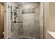 Shower featuring beautiful stone tiling, dual shower heads, and glass door at 6882 Snowshoe Trl, Evergreen, CO 80439