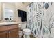 Cozy bathroom featuring a wooden vanity, neutral paint, and light/blue floral shower curtain for a pop of color at 23535 E Platte Dr # A, Aurora, CO 80016