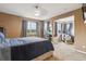 Spacious bedroom featuring a ceiling fan, neutral paint and an adjoining sitting area with three large windows at 23535 E Platte Dr # A, Aurora, CO 80016