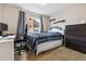 Comfortable bedroom with natural light, desk, a dark dresser, and neutral carpet with grey curtains at 23535 E Platte Dr # A, Aurora, CO 80016