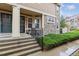 Charming townhome entrance with stone accents, landscaped garden, and a black wrought iron railing at 23535 E Platte Dr # A, Aurora, CO 80016