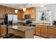 Inviting kitchen with stainless appliances, island with seating, and ample cabinet space at 23535 E Platte Dr # A, Aurora, CO 80016