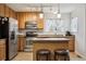 Functional kitchen featuring stainless steel appliances, a breakfast bar, and ample storage space at 23535 E Platte Dr # A, Aurora, CO 80016