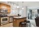 Well-lit kitchen with stainless steel appliances, island with seating, and direct view to the living area at 23535 E Platte Dr # A, Aurora, CO 80016