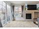 Bright living area with modern fireplace, ample natural light, and access to the outdoors at 23535 E Platte Dr # A, Aurora, CO 80016
