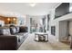 Bright living room featuring a cozy fireplace, plush carpet, and sliding door access to outdoor space at 23535 E Platte Dr # A, Aurora, CO 80016