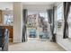 Bright living room with a sliding glass door to a private balcony and view of the neighborhood at 23535 E Platte Dr # A, Aurora, CO 80016