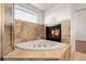 Inviting bathroom featuring a soaking tub and a fireplace for a relaxing spa-like experience at 44000 E 88Th Ave, Bennett, CO 80102
