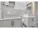 Modern bathroom with dual sinks, white vanities, tiled floors, large mirror, and a neutral color scheme at 44000 E 88Th Ave, Bennett, CO 80102