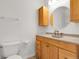 Classic bathroom featuring a wooden vanity with a bronze faucet and decorative mirror at 44000 E 88Th Ave, Bennett, CO 80102