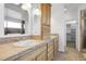 Bathroom featuring double sinks, wooden cabinets, and walk-in shower offering convenience and style at 44000 E 88Th Ave, Bennett, CO 80102