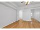 Bedroom with hardwood floors, closet doors and adjacent bathroom at 44000 E 88Th Ave, Bennett, CO 80102