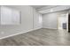 Spacious bedroom with light gray walls, vinyl flooring, natural light from two windows, and modern finishes at 44000 E 88Th Ave, Bennett, CO 80102