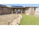 Charming brick home featuring a welcoming porch and a stone pathway leading to the front door at 44000 E 88Th Ave, Bennett, CO 80102
