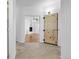 Entryway with tile floor, barn door and a view of the living room fireplace at 44000 E 88Th Ave, Bennett, CO 80102