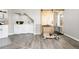 Bright laundry room with white appliances, gray vinyl flooring, barn door, and plenty of storage space at 44000 E 88Th Ave, Bennett, CO 80102