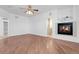 Spacious living room with hardwood floors, a fireplace, and plenty of natural light at 44000 E 88Th Ave, Bennett, CO 80102