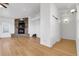Bright living room with hardwood floors and a stone fireplace adding cozy charm at 44000 E 88Th Ave, Bennett, CO 80102