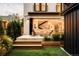 Inviting outdoor patio with fire pit, comfortable seating, and seamless indoor-outdoor flow with open doors at 1983 S Logan St, Denver, CO 80210