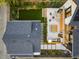 Aerial view of backyard featuring a modern patio, fire pit, outdoor dining, artificial grass, and professional landscaping at 1983 S Logan St, Denver, CO 80210