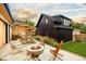 Backyard with outdoor patio, firepit, dining area, lush landscaping, and modern siding at 1983 S Logan St, Denver, CO 80210