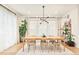 Dining area featuring a modern chandelier, natural lighting, and stylish décor at 1983 S Logan St, Denver, CO 80210