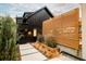 Modern black home exterior featuring a privacy screen, stone pathway, professional landscaping, and modern lighting at 1983 S Logan St, Denver, CO 80210