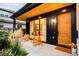 Inviting front porch with wood accents, modern lighting, and decorative outdoor seating arrangement at 1983 S Logan St, Denver, CO 80210