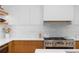 Modern kitchen featuring stainless steel appliances, subway tile backsplash and wood cabinetry at 1983 S Logan St, Denver, CO 80210