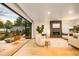 Living room with sliding glass doors opening to an outdoor firepit and seating area at 1983 S Logan St, Denver, CO 80210