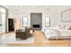 Bright main bedroom featuring a fireplace, hardwood floors, and a comfortable seating area at 1983 S Logan St, Denver, CO 80210