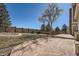 Stone patio and walkway lead to a wooden deck and fenced yard at 4240 S Yukon Way, Lakewood, CO 80235