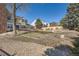 Large, grassy backyard featuring a deck, mature trees, and a stone walkway at 4240 S Yukon Way, Lakewood, CO 80235