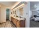 Well-lit Primary bathroom with a double sink vanity, wood cabinets, and ample storage space at 4240 S Yukon Way, Lakewood, CO 80235