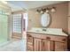 Bathroom vanity with a white countertop, oval mirror, and decorative light fixture at 4240 S Yukon Way, Lakewood, CO 80235
