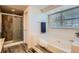 Bright bathroom with a bathtub, shower, and tiled walls, perfect for relaxation at 4240 S Yukon Way, Lakewood, CO 80235