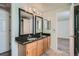 Elegant bathroom featuring a double sink vanity, updated fixtures, and mirrors at 4240 S Yukon Way, Lakewood, CO 80235