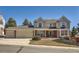 Traditional two-story home boasts a three-car garage and a manicured front yard at 4240 S Yukon Way, Lakewood, CO 80235