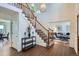 Elegant foyer with a staircase, hardwood floors, and views into the living spaces at 4240 S Yukon Way, Lakewood, CO 80235