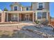 Charming front porch with brick accents and landscaped garden with decorative rock at 4240 S Yukon Way, Lakewood, CO 80235