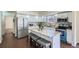 Updated kitchen features white cabinets, stainless steel appliances, and a large island with bar seating at 4240 S Yukon Way, Lakewood, CO 80235