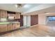 Finished basement kitchenette with natural wood cabinets, sink, and tile backsplash at 4240 S Yukon Way, Lakewood, CO 80235