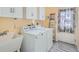 Laundry room equipped with sink, washer, dryer and ample cabinet storage space at 4240 S Yukon Way, Lakewood, CO 80235